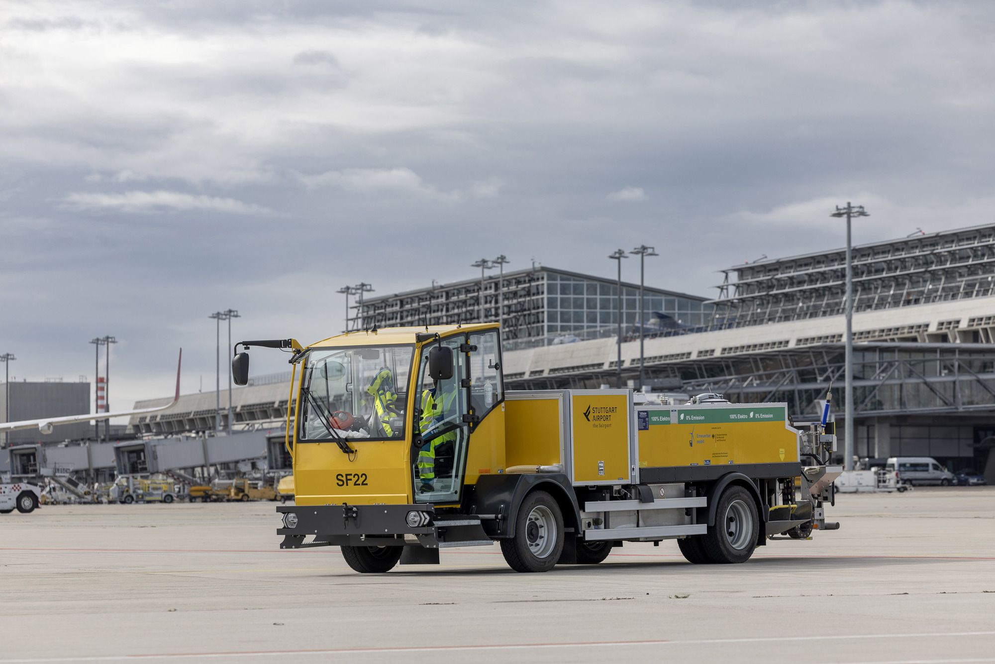 Ein elektrischer Abpumpwagen wird an ein Flugzeug angeschlossen.